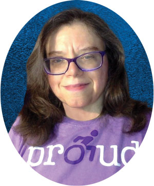 Author karol ruth silverstein wearing a purple shirt that says proud with an icon of a person using a wheelchair